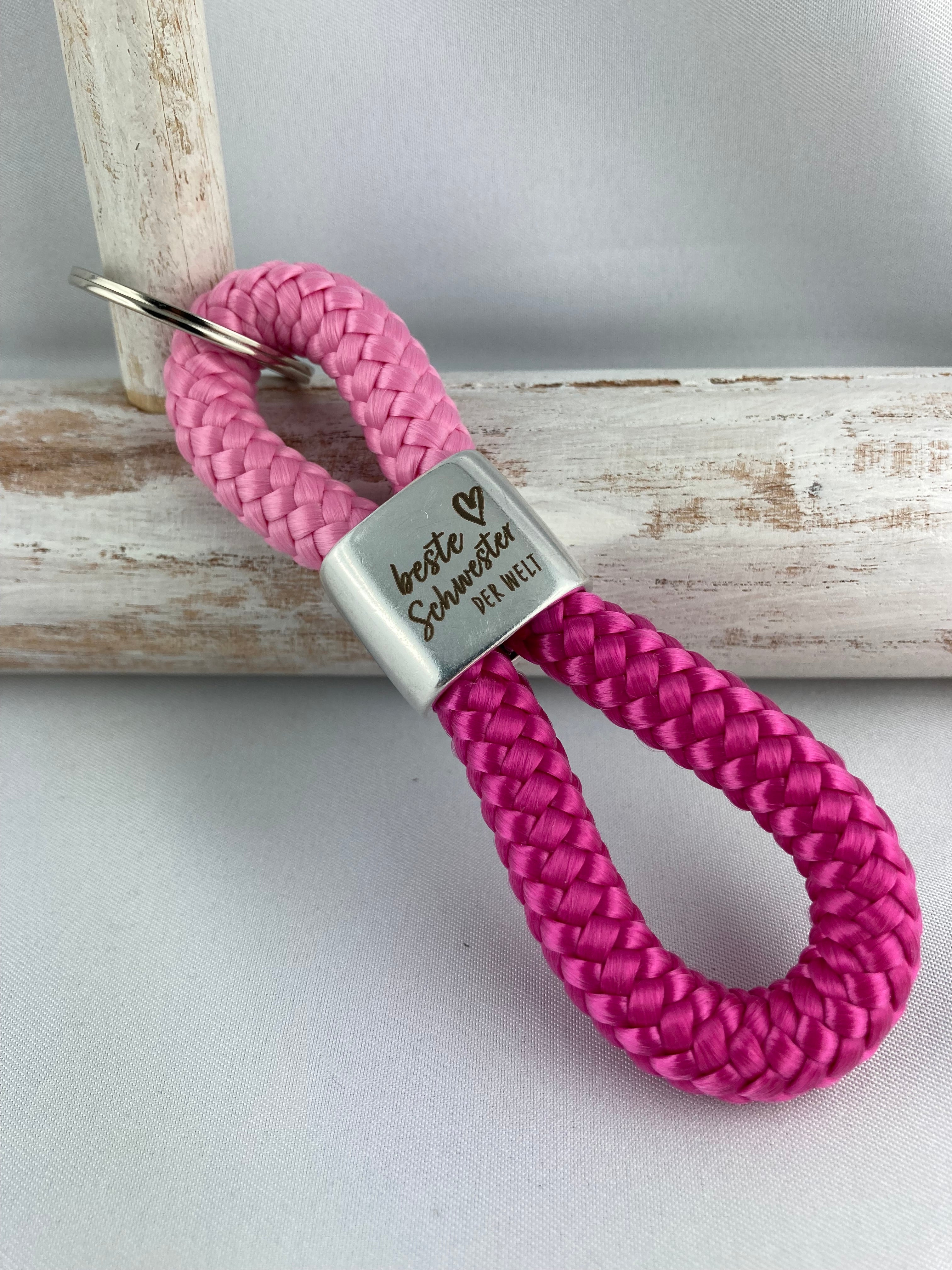 Schlüsselanhänger aus Segelseil mit Gravur "Beste Schwester der Welt" - rosa/ fuchsia