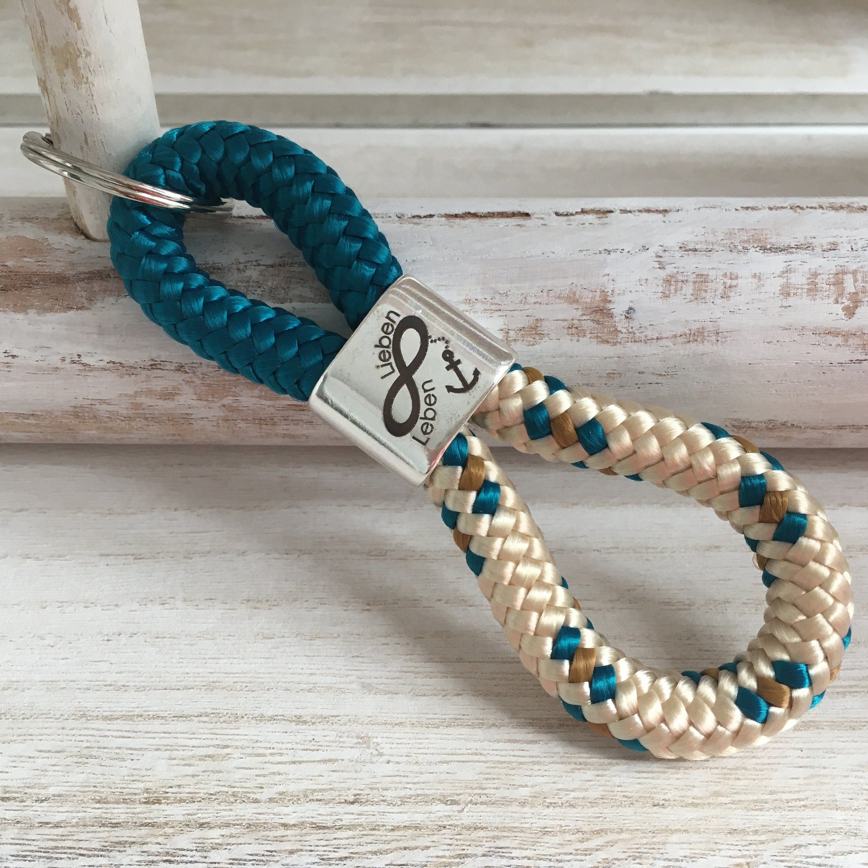 Schlüsselanhänger aus Segelseil mit versilbertem Zwischenstück mit Gravur "Unendlich Lieben, unendlich Leben", petrol/ beige-petrol-curry