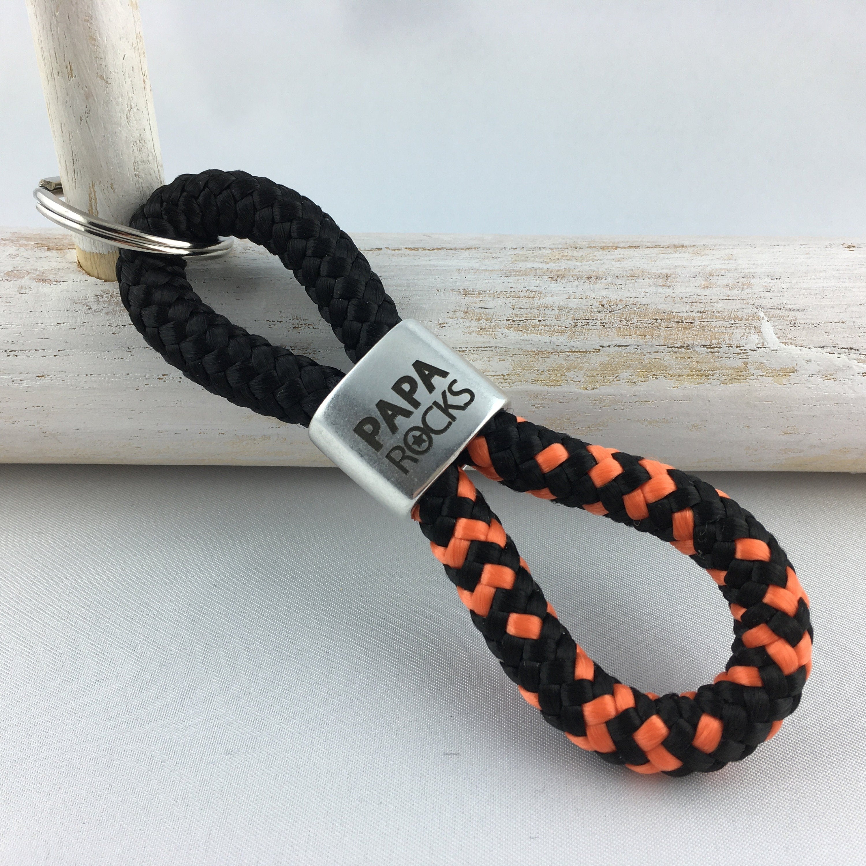 Schlüsselanhänger aus Segelseil mit versilbertem Zwischenstück mit Gravur "PAPA ROCKS", schwarz/ schwarz-orange