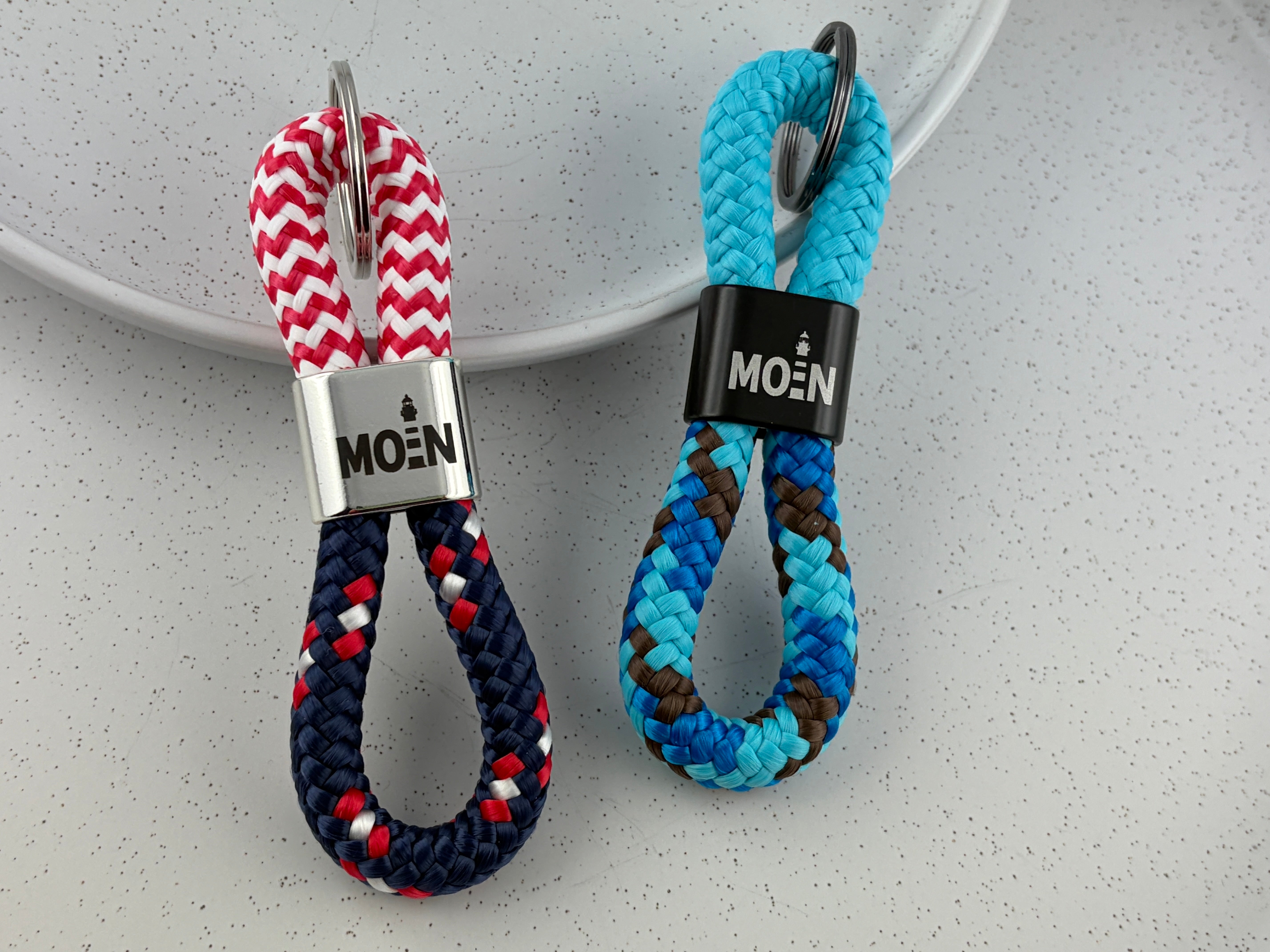 Handgefertigter MOIN-Schlüsselanhänger aus Segelseil mit Leuchtturm-Motiv und verschiedenen Seilfarben
